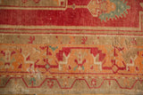 Low pile on distressed Oushak rug with faded raspberry red and tangerine patterns.