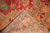 Hand-knotted weave foundation and distressed pile with faded red, orange, aqua geometric patterns.