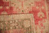 Detail of vintage distressed Oushak rug showing low pile and hand-knotted reverse.