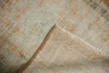 Detailed view of distressed vintage Oushak rug pile, revealing its striped hand-knotted foundation.