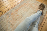 Soft texture and distressed pile of a vintage Oushak rug in muted apricot and ivory.