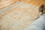 Hand knotted distressed Oushak rug texture with even wear; apricot, ivory, navy tones.