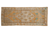 Distressed Vintage Oushak runner, saffron yellow floral medallion, ivory field, aqua accents.