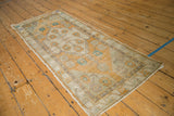 Vintage distressed Oushak runner pile texture and foundation visible at folded edge.