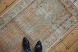 Distressed vintage Oushak runner, faded orange, ivory, and silver with tree of life motifs.
