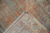 Distressed Oushak rug runner pile with visible foundation on folded corner.