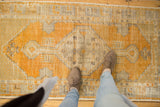 Distressed Oushak runner, worn pile, gold orange diamond medallion, ivory, silver tones.