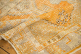 Distressed gold orange and antique ivory geometric patterns on a vintage Oushak rug.