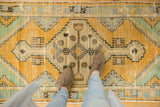 Distressed Oushak runner, gold orange diamond medallion, mint patterns, visible foundation wear.