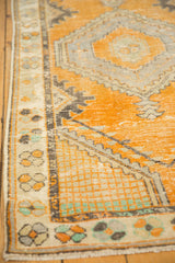 Distressed Oushak rug pile, tangerine orange with silver geometric pattern and mostly even wear.