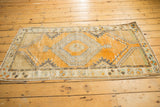 Distressed tangerine orange field, lattice corner spandrels, and meandering vine main border.