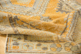 Folded vintage distressed Oushak runner, orange and silver geometric patterns.