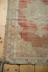 Even wear to the knot heads and secured side on a distressed vintage Oushak rug.