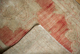 The hand-knotted foundation and evenly worn pile of a distressed vintage Turkish rug.