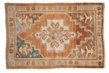 Vintage Distressed Oushak rug, stepped medallion, ram's horn motifs, copper, sky blue, and bronze tones.