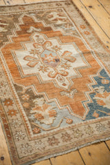 Distressed copper and sky blue Oushak rug showing starburst floral border details.