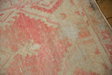 Distressed vintage Oushak rug showcasing textured blush and beige pile wear.