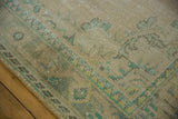 Worn knot heads and muted green angular border pattern on vintage distressed Oushak rug.