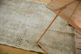 Close-up of distressed vintage Oushak rug runner, revealing tone-on-tone beige pattern and wear.