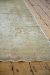Distressed beige Oushak runner texture with visible wear to foundation and knot heads.