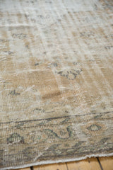 Vintage distressed Oushak rug pile with even wear to foundation, faded ivory, beige, and soft green.