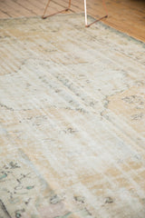 Distressed texture and even wear on knot heads of a vintage Oushak rug in ivory and beige.