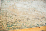 Distressed Oushak rug texture with even wear, faded ivory, beige, and sea-foam green floral motifs.