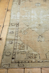 Distressed vintage Oushak runner with worn pile, geometric motifs, and visible foundation.