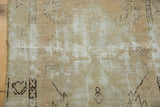 Distressed Oushak rug section with antique ivory faded motifs and exposed foundation.