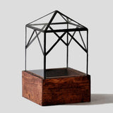 Glass Elias Trap terrarium, dark wood base, black frame pyramid hip roof.