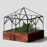 Angled Glass Cottage Terrarium with dark reclaimed wood base and pyramid hip roof.