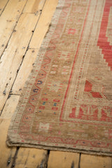 Distressed vintage Oushak rug, faded bronze field with pale red geometric border.