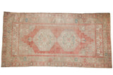 Distressed vintage Oushak runner with double medallions, muted blush, beige, and seafoam tones.