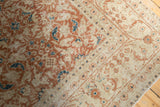 Worn texture and terra cotta floral motifs on this distressed Sivas carpet.