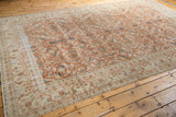 Distressed vintage Sivas carpet border, terra cotta and ivory floral pattern, worn pile.