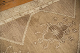 Oushak rug detail: intricate geometric pattern and step-wrapped border in oxidized silver, bronze.