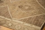 Textured, distressed pile of a vintage Oushak rug with oxidized silver and bronze geometric motifs.