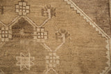 Distressed Oushak rug detail: low pile, abrashes, geometric drawing in bronze and silver tones.