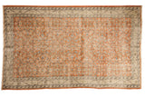 Distressed vintage Oushak carpet, pale rust orange field with faded allover floral design, ivory border.