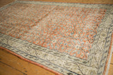 Faded rust orange floral field with vinery on a distressed vintage Turkish Oushak carpet.