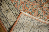 Distressed pale rust Oushak pile with foundation showing, revealing secured side and woven reverse.