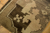 Low pile rectilinear pattern on vintage Oushak runner in coffee brown, antique ivory, and blush.