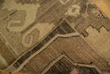Low pile vintage Oushak rug with rectilinear design and visible hand-knotted reverse.