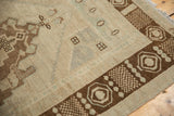 Vintage Oushak rug corner, chocolate bronze germinating seed border, ivory field, and distressed pile.