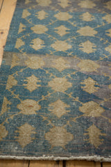 Distressed vintage Sparta runner, aqua blue and gold floral lattice, abrashes, and short fringe.