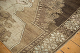 Vintage Oushak rug border detail, showing geometric motifs in brown, ivory, and pale blush.