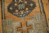 Distressed Oushak rug texture with angular motif in pale orange rust and oxidized silver.