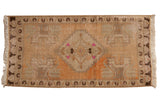 Distressed hand-knotted Oushak rug with faded peach, ivory, brown tones and a stepped medallion.