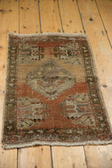 Vintage distressed Oushak rug corner showing worn copper pile, visible foundation, and fringe.