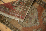 Distressed Oushak rug fringe with worn copper, bronze, and beige pile detail.